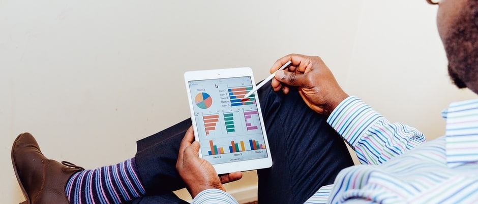 Man creating financial plan on tablet